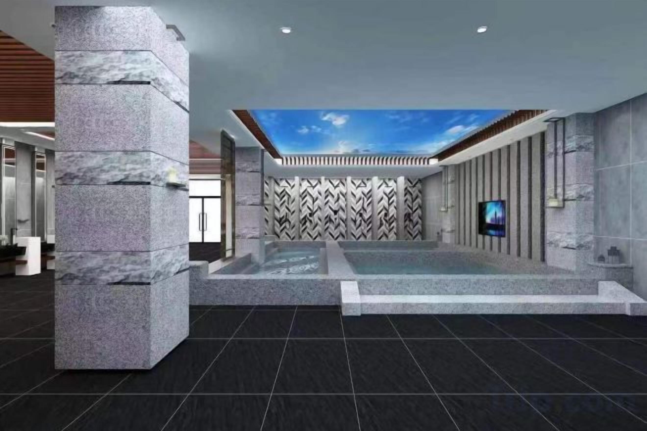 A modern lobby with a stone column, a patterned wall, a ceiling with a sky-like design, and a flat-screen TV.