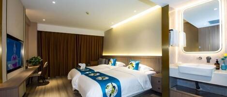 A modern hotel room with a large bed, a desk, a TV, and a bathroom with a mirror and sink.