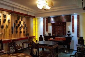 A traditional interior with a dining area, wooden wall decorations, and a traditional table. - Jianhe Hot Spring Linsen Collection Theme Hotel (Jianhe)