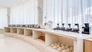 A modern hotel room with a marble console table, a coffee station, and a view of the city. - Lantian Hotel (Hulunbuir Ancient City) (Hulunbuir)