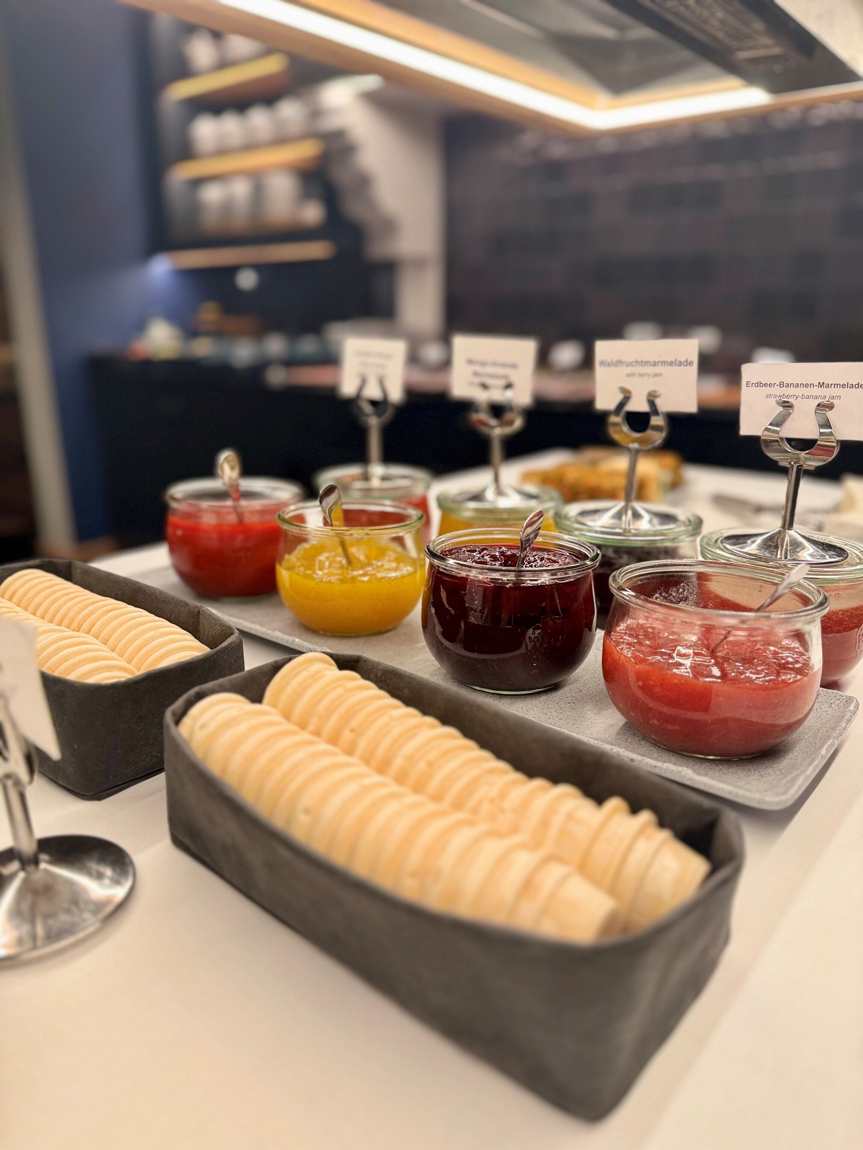 A buffet with various food items and condiments.