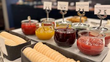 A buffet with various food items and condiments.