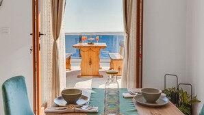 A dining area with a view of the sea, a wooden table, and a chair. - Rina Apartments - Superior One Bedroom Apartment with Terrace and Sea View (Baric Draga)
