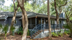 A house with a covered porch, a staircase, and a screened area. - 3 BR/2BA Home! Screen Porch! Amenity access included! (Seabrook Island)