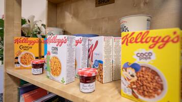 Cereal boxes and jars on a shelf.