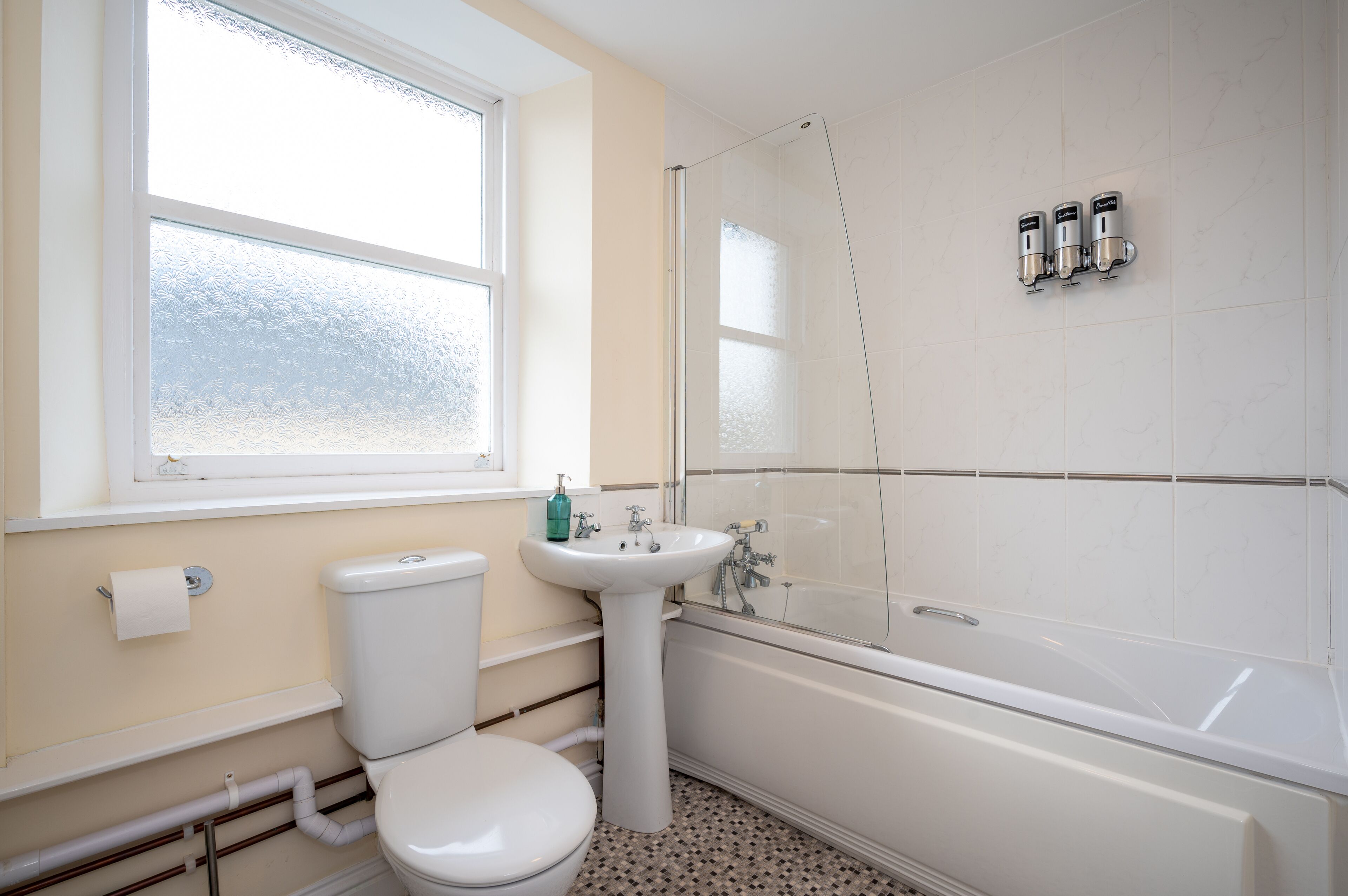 Un baño con inodoro, lavabo y bañera.