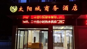 A hotel with a modern interior, a visible reception area, and a sign indicating wifi availability.