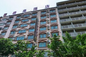 A multi-story hotel with balconies, a central staircase, and a row of windows on each floor. - Juntailai Hotel (Wenchang)