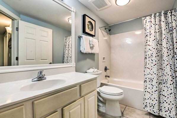 A bathroom with a sink, toilet, and shower. - Beachfront Condo w/Pool, Hot Tub & Beach Chairs Included (Panama City Beach)