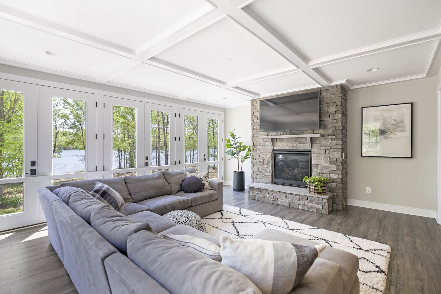 Open living room with amazing water views, comfy couch, Smart TV, and gas fireplace.