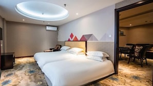 A hotel room with a large bed, a desk, and a chair. There is a ceiling light and a wall-mounted TV. - Borrman (hangzhou xianghu) (Hangzhou)