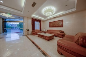 A spacious lobby with a large seating area, a chandelier, and a view of the outside. - Borrman (hangzhou xianghu) (Hangzhou)