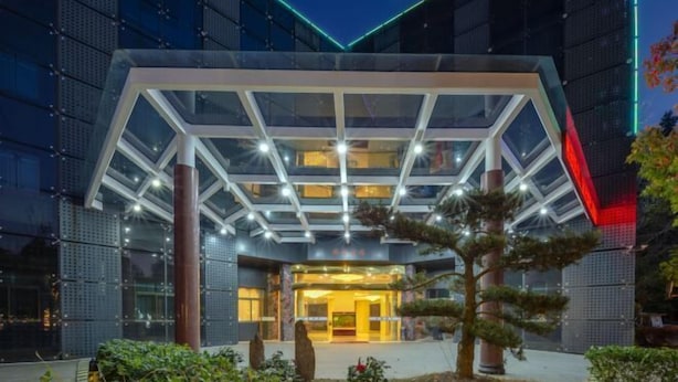 A modern hotel entrance with a glass atrium and a geometric facade. - Borrman (hangzhou xianghu) (Hangzhou)