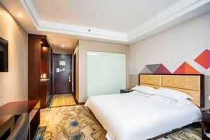 A hotel room with a bed, bedside table, and a wall-mounted TV. - Borrman (hangzhou xianghu) (Hangzhou)