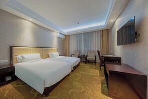 A hotel room with two beds, a desk, a chair, and a TV mounted on the wall. - Borrman (hangzhou xianghu) (Hangzhou)