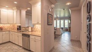 A spacious kitchen with white cabinetry, a dishwasher, and a tiled backsplash. - St James Golf Resort-Luxe 3/3 Condo, Sleeps8, Pool, 1DogOk, Gated (St. James Bay)