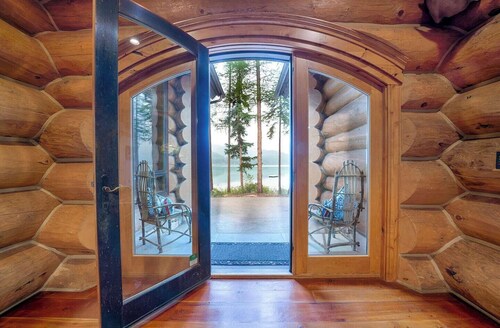 A stunning Montana log retreat on 50 secluded acres on Ashley Lake-perfect for large groups, featuring rustic luxury, expansive spaces, and room for up to 14 guests.