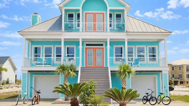 A two-story house with a front porch, a garage, and a balcony.