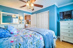 A bedroom with a bed, a dresser, a television, and a ceiling fan. - Beautiful Brigantine Condo - Walk to Beach! (Brigantine)