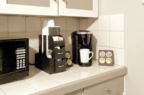 Enjoy cooking and brewing in this fully equipped kitchen with a microwave, coffee maker, and coffee pod holder.