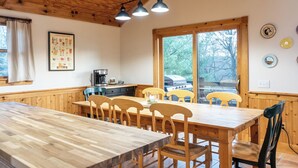 A wooden dining area with a large table and chairs, a coffee machine, and a view of the outdoors through a large window. - 3 Bedroom, 3.5 bath home in The Galena Territory (Galena)
