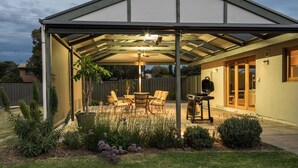 A covered patio with a grill, outdoor furniture, and a garden. - Riverport Retreat - Pet Friendly, close to the river, free Wifi + linen included (Goolwa South)