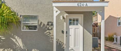 A single-story house with a white door and a small porch.