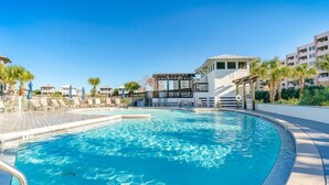 A swimming pool with a wooden deck, lounge chairs, and a pergola. - Breathtaking Home w/Private Pool, Walk 2 Beach w/Beach Wagon, Pools, Hot Tub, Tennis - Destin Pointe (Destin)