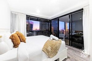 Enjoy a restful night's sleep in this spacious room with a large bed and stunning city views.