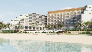 A hotel with multiple floors, a pool, and palm trees. - Muong Thanh Luxury Xuan Thanh Hotel (Tien Dien)