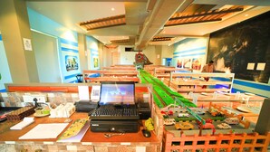 A reception area with a model train display, a laptop, and various office supplies. - Royal Rich County (Gangavathi)