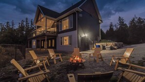 A modern two-story house with a deck and outdoor seating area. - Huronia Luxury: Lakefront Views and Game Room (Mar)