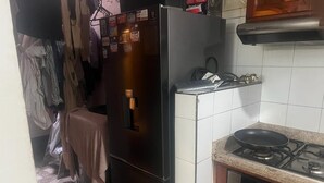 A compact kitchen with a refrigerator, a stove, and a tiled backsplash. - Come to me (Cali)