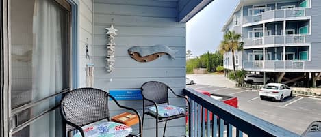 A balcony with two chairs and a starfish decoration.