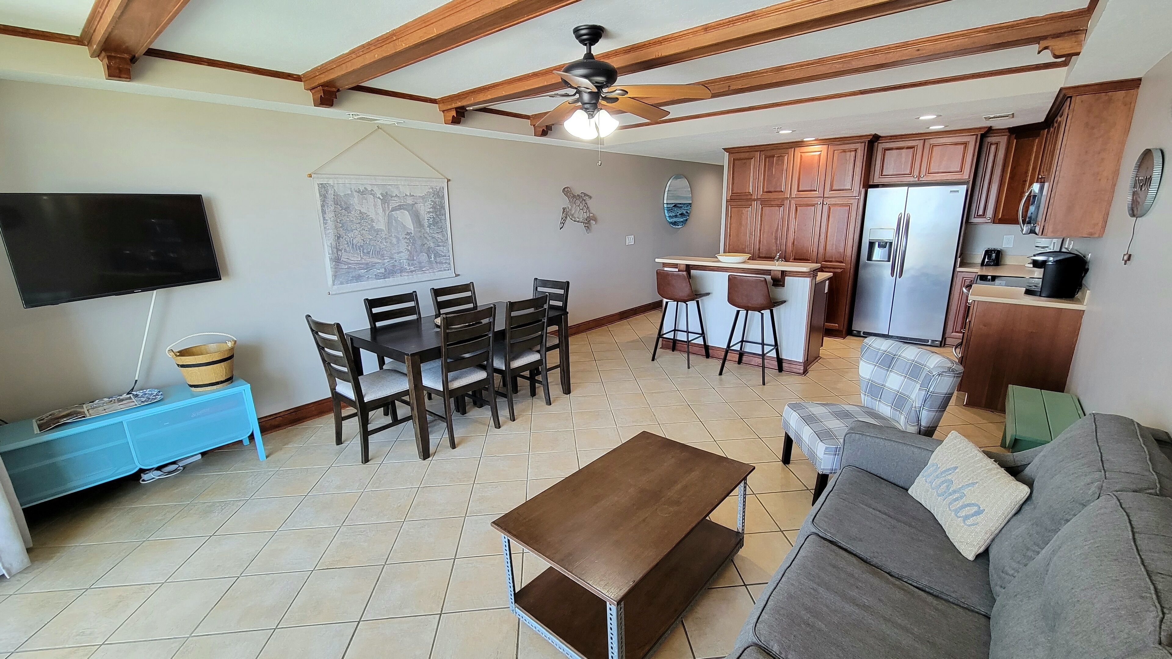 A compact living space with a dining area, kitchen, and seating area.