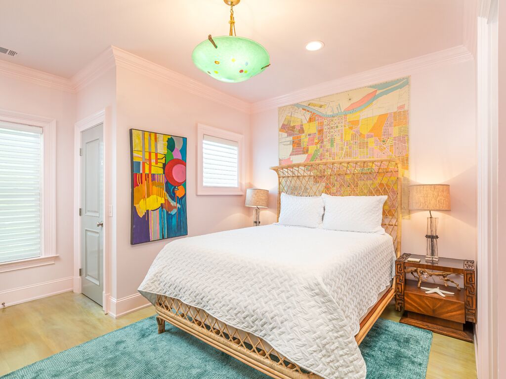 A bedroom with a bed, a map mural, and a wooden headboard.