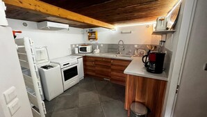 A compact kitchen with a microwave, toaster, and coffee maker. - Ground floor, parking, tv, 62m², Arêches-Beaufort (Beaufort)