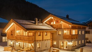 A large wooden chalet with multiple balconies and a snow-covered ground. - Engadin Chalet Appartment- Val Bever St.Moritz ideal for 2 persons. New! (Bever)
