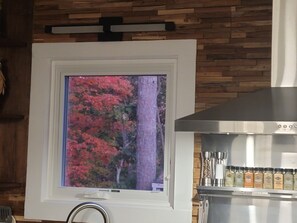 A framed picture of autumn foliage on a wall, a stainless steel range hood, and a spice rack with various seasonings. - Outdoorsman's Paradise at The Shady 180 - Lakeviews
Spa, Kayak, Golf, Hike, Fish (Waleska)