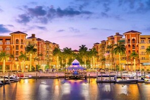 A waterfront hotel with multiple buildings, a marina, and a central pavilion. - Golf Membership Available! Top Floor Condo, Pickleball, Near Naples Beaches (Naples)