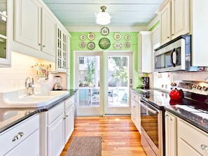 Enjoy cooking in this well-equipped kitchen with a stainless steel sink, microwave, and kettle.