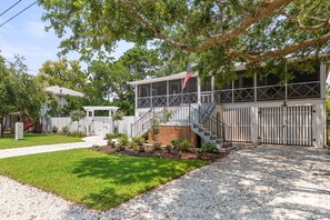Stroll through the beautifully manicured lawn to the inviting porch area of this modern home.