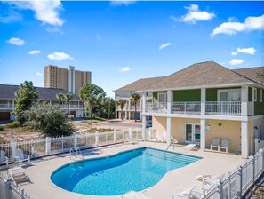 Relax by the hotel's rectangular pool surrounded by lounge chairs and a deck area.
