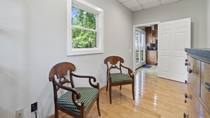 A kitchen with wooden cabinets and a window overlooking greenery. - Mountain View Cabin in VA Wine Country (Scottsville)