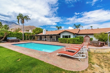 Backyard features a private pool and plenty of comfortable spaces to lounge.