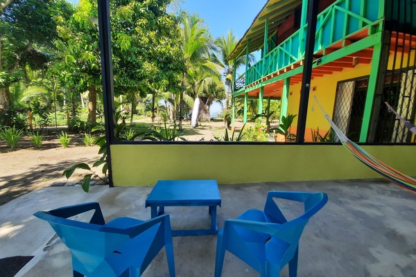 View from the covered patio with table, chairs and hammocks.