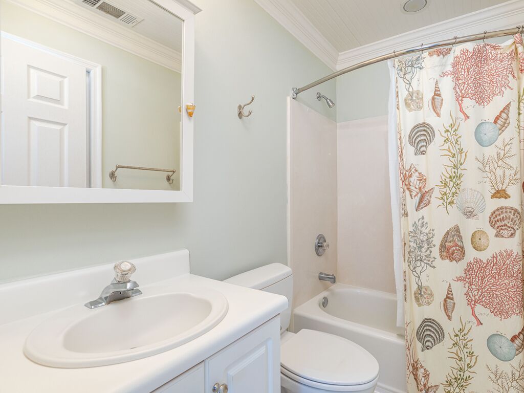 A bathroom with a sink, toilet, and bathtub.