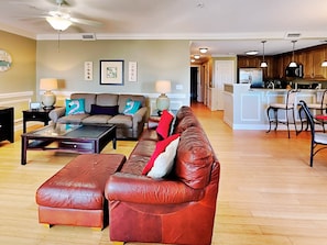 Relax in this stylish living room with a comfortable sofa, ottoman, and coffee table.
