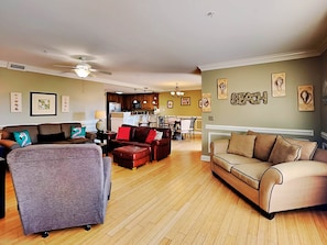Relax in this stylish living room with a grey sofa, brown leather sofa, and a comfortable armchair.