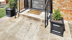 A brick building with a front door, two potted plants, and a welcome mat. - On Austin Ave!!! Completely remodeled and close to Magnolia, Downtown & Baylor.  (Waco)